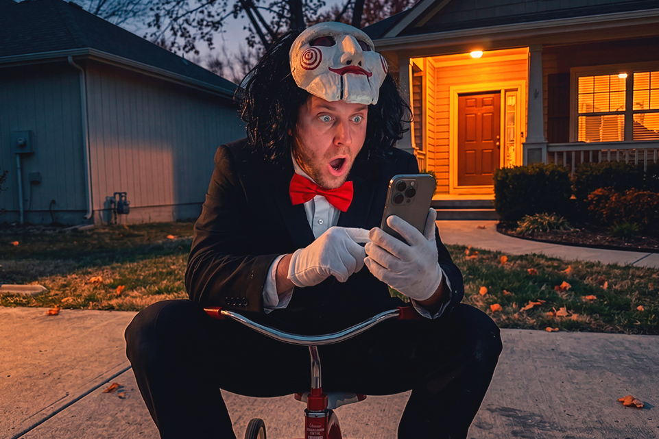 Vampire outside a house decorated for Halloween at night, illustrating unclaimed lottery prizes.